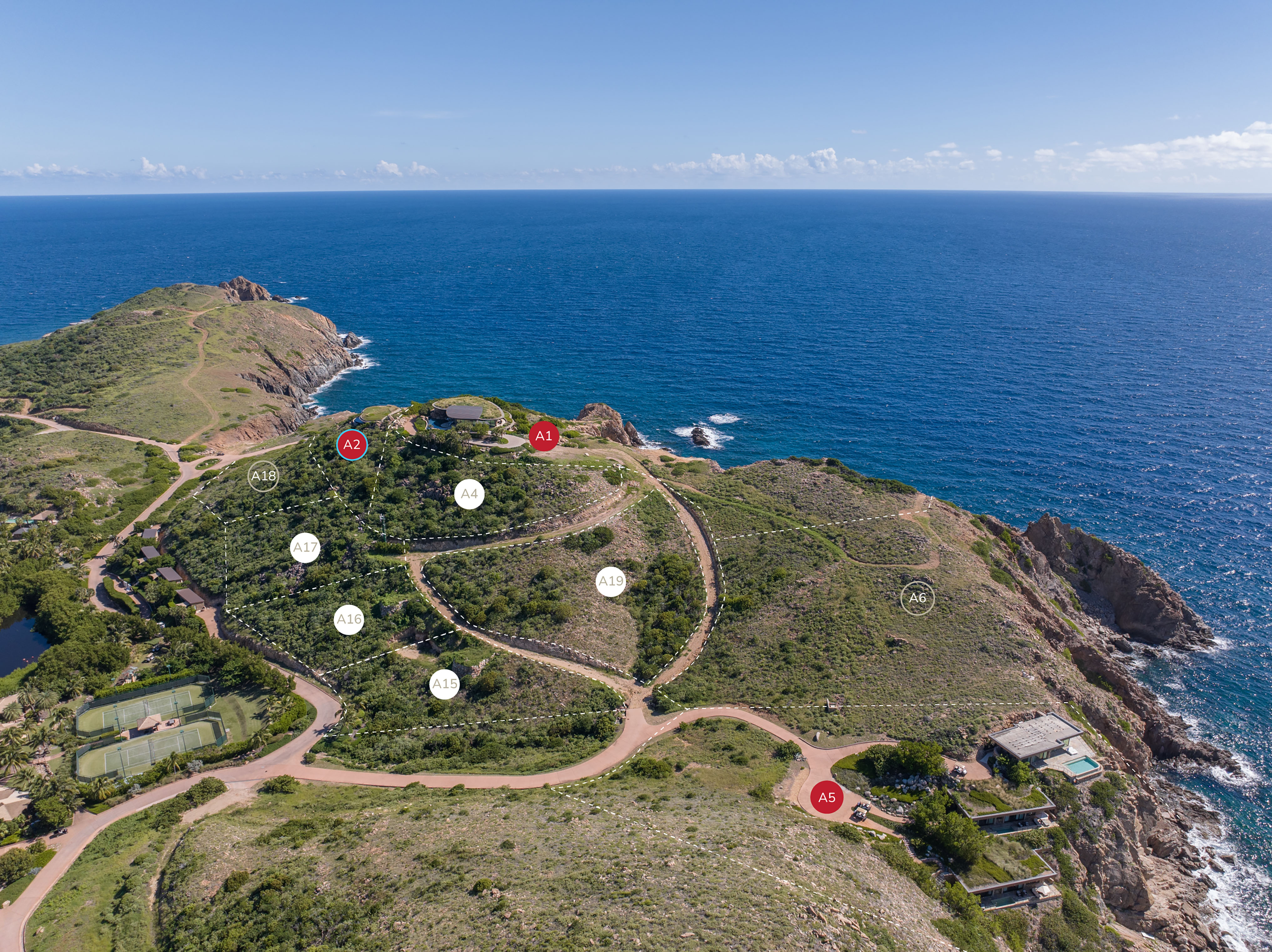 Aerial view of a coastal landscape featuring lush greenery, winding dirt roads, and rocky cliffs overlooking the vast blue Atlantic Ocean. Several plots of land are marked with labels like A1, A2, A3, suggesting designated areas along the ridge. Cloud-dotted sky in the background.