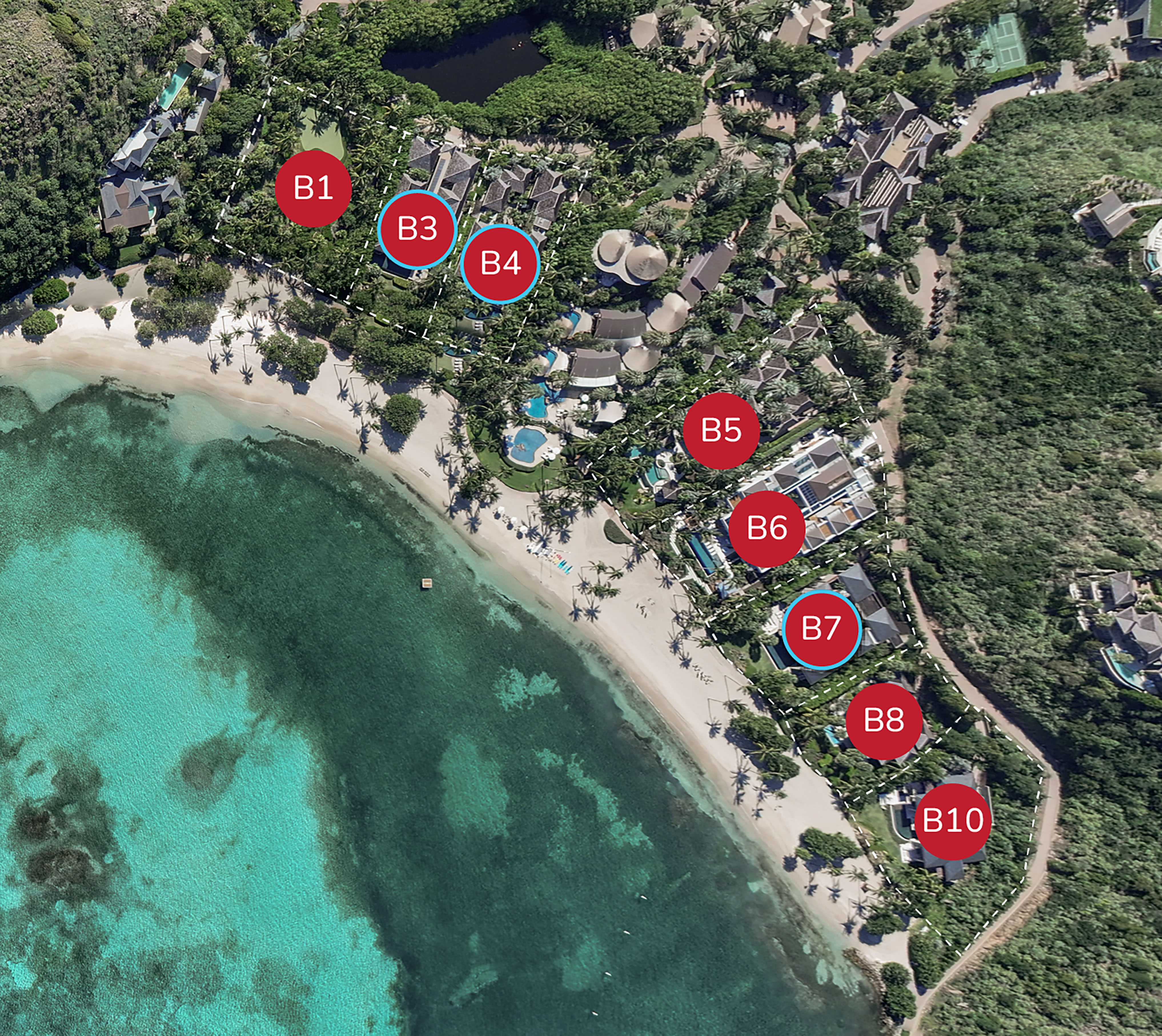 An aerial view of a coastal resort by the beach showcases lush greenery, with accommodation units marked B1 through B10. The pristine shoreline meets clear, turquoise waters. Pathways and buildings are scattered throughout the scenic resort area.