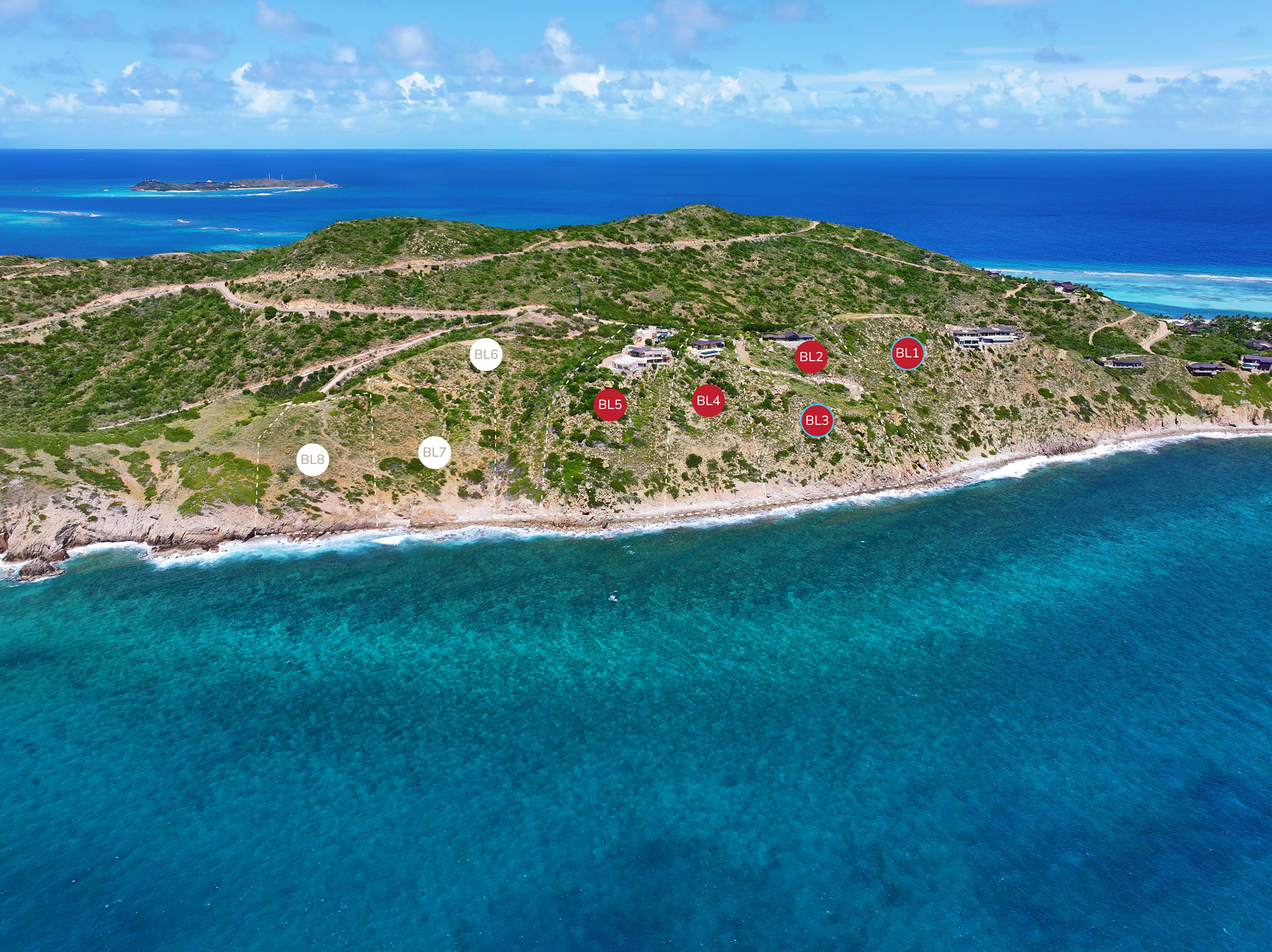 Aerial view of a coastal landscape with green hills and clear turquoise ocean water. Several plots of land on the hillside, near a large boulder, are marked with red and white labels (B1-B6), indicating their locations. The sky is clear with a few scattered clouds.