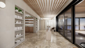 Welcome to Sundara Spa—a modern, minimalist studio with wooden ceiling slats and large glass windows. Shelves filled with products line one wall, while a serene ocean view beckons through the windows. Neutral tones and a calm atmosphere pervade this tranquil space. Coming soon for your ultimate relaxation.